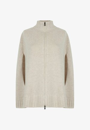 Cremfarbener gestrickter Pullover mit hohem Kragen, Reißverschluss und seitlichen Öffnungen. Besitzt gerippte Bündchen und Saum sowie einen strukturierten Stoff.