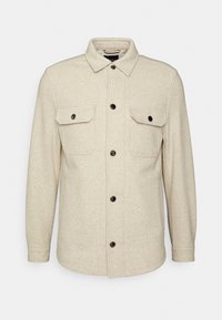 Beige flanellen overhemdjasje, met een kraag, knoopsluiting, twee borstzakken met klep en lange mouwen.