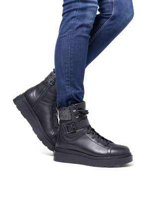 Black leather ankle boots with a textured back panel, lace-up front, and a side zipper. Thick rubber sole for added traction and support.