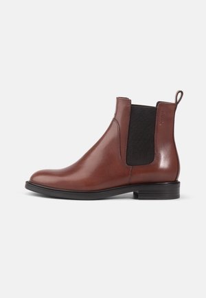 Brown leather Chelsea boots with elastic side panels, round toe, and a low black rubber heel. Smooth finish and minimal detailing.