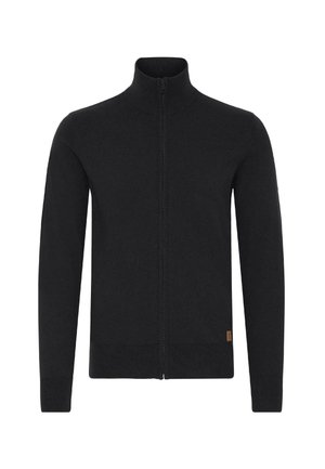Črna zip-up jopica iz pletenine z visokim ovratnikom, dolgimi rokavi in majhno etiketo na spodnji strani.