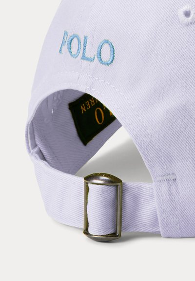 White cotton baseball cap featuring light blue "POLO" embroidery, an adjustable strap with a silver metal buckle on the back.