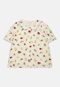 Kortermet bluse med krage i kremfarget stoff med blomstermønster i rød, gul og blå, featuring knappestolpe og volangerm.