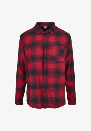 Punase ja musta ruudulise flanell-särgi pika varrukaga, ees nööbitav ja rinnataskuga, millel on diagonaalne ruudumuster.