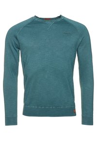 Felpa lunga color teal realizzata in tessuto testurizzato. Presenta polsini e orlo a costine, con un piccolo logo sul petto. Design classico con collo a girocollo.