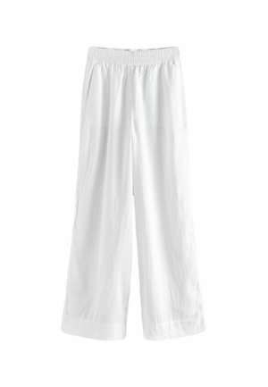 Pantalon blanc ample avec taille élastique et jambes larges, conçu pour une tenue décontractée.