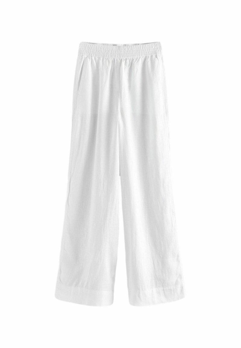 Pantalon blanc ample avec taille élastique et jambes larges, conçu pour une tenue décontractée.