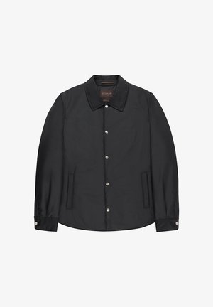 Veste noire boutonnée avec col et deux poches latérales, présentée à plat sur un fond blanc.