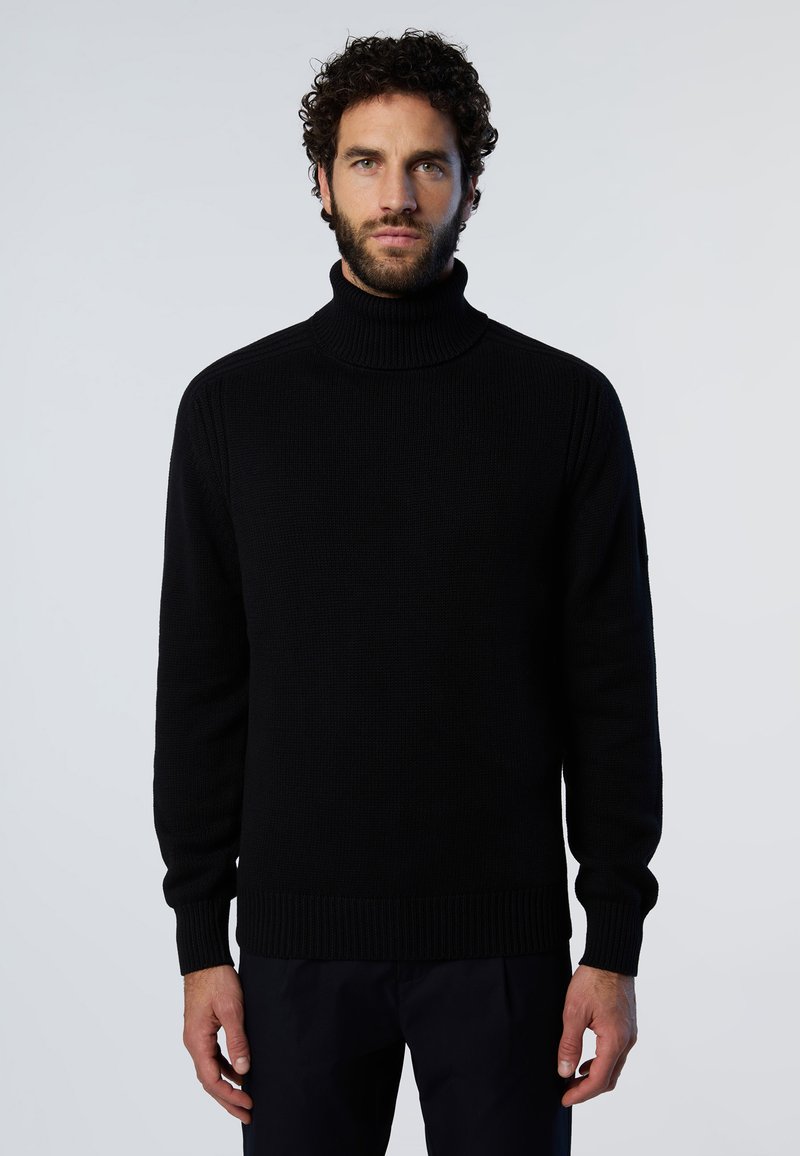 Maglione a collo alto lavorato a maglia nera con polsini e orlo a costine, caratterizzato da un motivo testurizzato e design semplice, realizzato in un tessuto morbido e spesso.
