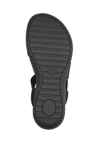 Sole in gomma nera con scanalature orizzontali e verticali per aderenza, caratterizzata da un accento circolare con indicazioni di misura e un bordo liscio.