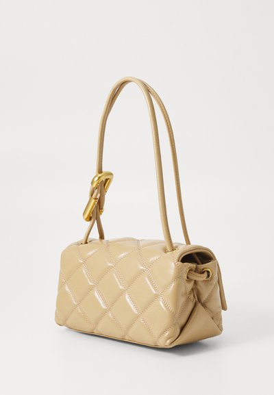Quilted leather handbag in light beige with a structured shape, a single shoulder strap, and a gold-tone hardware accent.