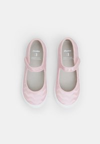 Zapatos Mary Jane de tela rosa con una textura ondulada, suelas de goma blanca y una correa de Velcro en la parte delantera. Interior forrado en gris claro.