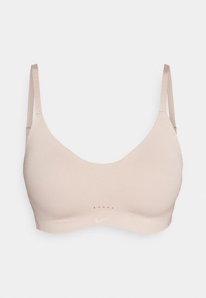 Svetlo roza športni modrček, izdelan iz gladkega blaga z okroglim izrezom, tankimi nastavljivimi naramnicami in diskretnimi pikčastimi poudarki spredaj.