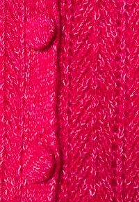 Knitted pink cardigan with a textured herringbone pattern and two round, knitted buttons along the opening. Soft yarn fabric.
