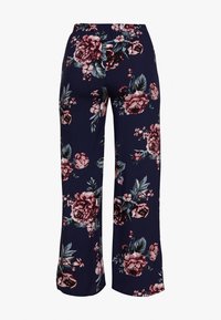 Navy floral pants with a relaxed fit, featuring large pink and white roses, green leaves, and an elastic waistband for comfort.