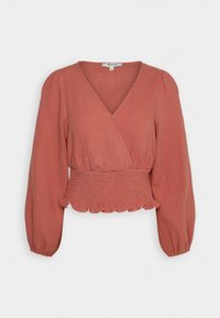 Blusa color ruggine con scollo a V, vita arricciata e maniche lunghe a sbuffo. Il tessuto testurizzato con orlo arricciato aggiunge un tocco di dettaglio.