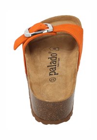 Orange suede sandal with a wide strap and silver buckle, featuring a brown cork footbed and textured sole.