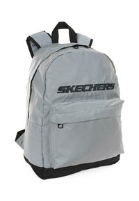 Mochila de tela gris con acentos negros, presenta un compartimento principal, un bolsillo frontal con cremallera y correas ajustables. Logo exhibido en la parte delantera.