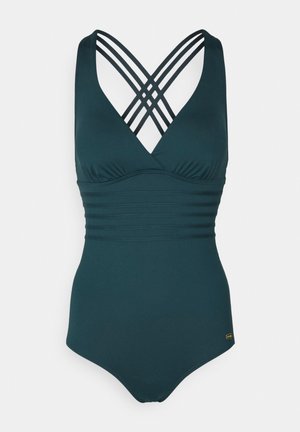Dunkelgrüner einteiliger Badeanzug mit gekreuzten Trägern im Rücken, strukturiertem Oberteil und glatter Oberfläche. Hat einen schmeichelhaften V-Ausschnitt.