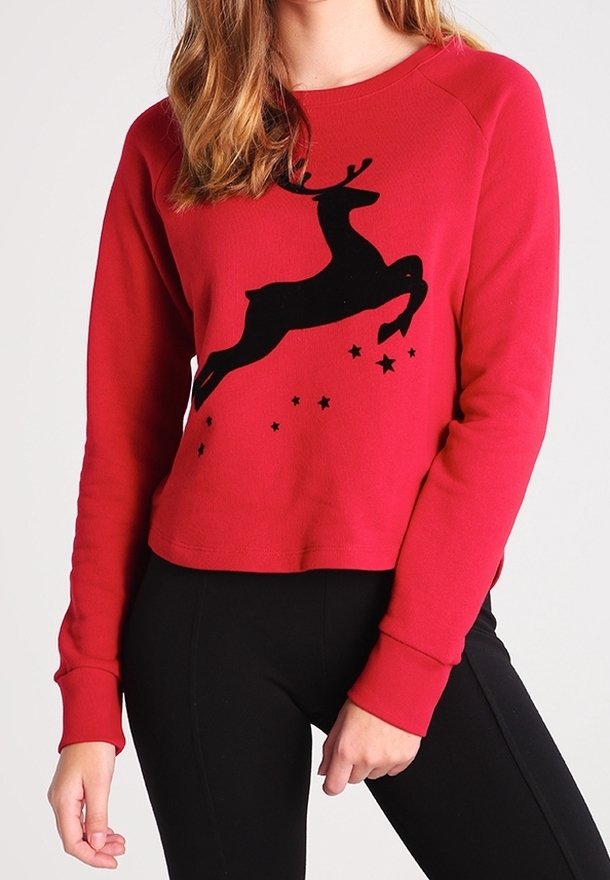 Felpa rossa con silhouette di un renna nera decorata con stelle, realizzata in un morbido tessuto, design corto e polsini a coste.