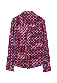 Langarmshirt aus gemustertem Stoff mit ineinandergreifenden Formen in Rot, Rosa, Blau und Weiß auf dunklem Hintergrund. Mit Kragen und Knopfmanschetten.