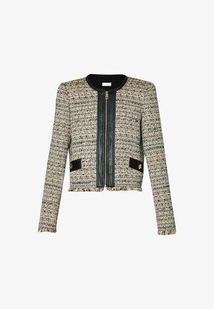 Giacca aderente in tessuto beige e nero con un pannello frontale in pelle, lunghezza cropped e dettagli neri a contrasto.