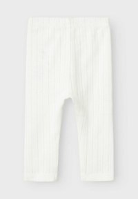 Leggings en coton blanc avec une texture côtelée verticale, une taille élastique et un ourlet de cheville ajusté. Convient pour une tenue décontractée ou confortable.