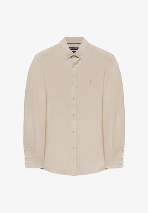 Beige langærmet skjorte med button-down krave, med en lille broderet logo på brystet og knapdetaljer på manchetterne.