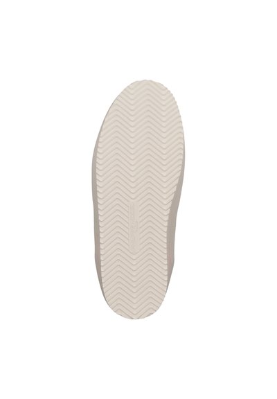 Shoe sole featuring a textured rubber material with a zigzag tread pattern, in light beige, with a subtle branding element on the side.