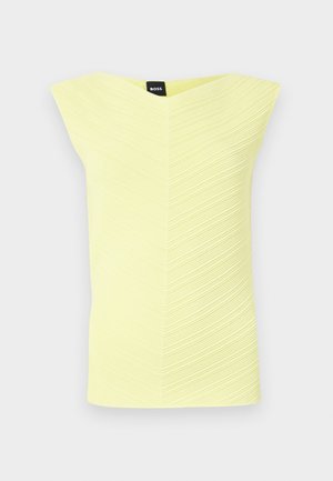 Haut sans manches texturé jaune avec un décolleté en V et un motif à rayures horizontales, étiquette de marque visible au niveau du décolleté.