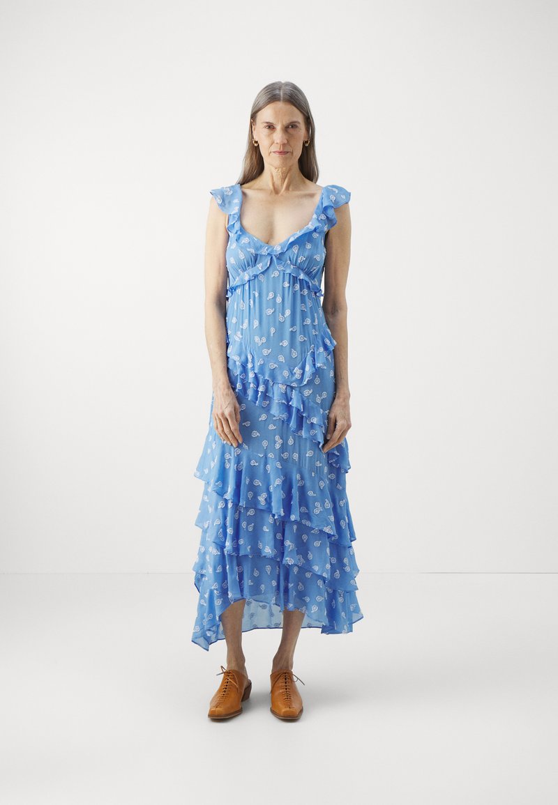 Blue floral maxi dress with ruffled straps and multiple layered tiers. Made of lightweight fabric, features white patterned details and a deep neckline.