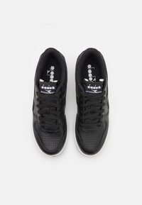 Black sneakers with a smooth leather upper, perforated toe, white rubber sole, and black laces. Features "diadora" branding on the tongue.