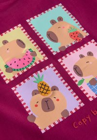 Cuatro osos de dibujos animados sobre un fondo rojo, cada uno enmarcado con un borde a rayas y sosteniendo o llevando una fruta diferente.