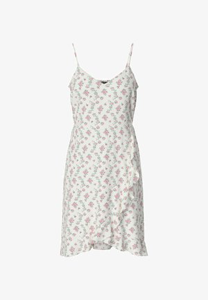 Abito a sbuffo floreale con spalline sottili, caratterizzato da una base bianca e piccoli fiori rosa. Orlo arricciato e tessuto morbido con una texture liscia.