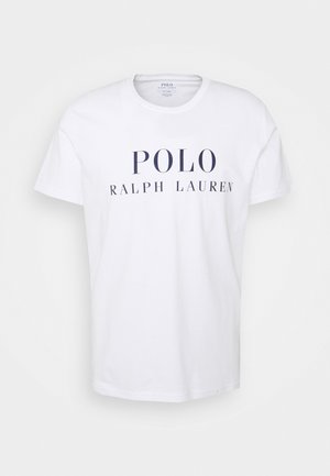 T-shirt bianco in cotone con la scritta "POLO RALPH LAUREN" stampata in blu navy. Maniche corte e scollo a giro. Design a vestibilità classica.