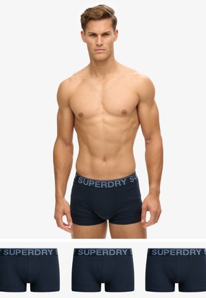 Boxers en coton bleu marine avec une ceinture grise contrastante arborant le logo "SUPERDRY". Texture douce, design ajusté et longueur standard.