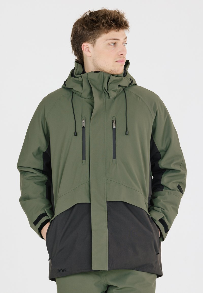 Grüne und schwarze wasserdichte Jacke mit hohem Kragen, verstellbare Kapuze, Reißverschlusstaschen und einer strukturierten Stoffoberfläche.