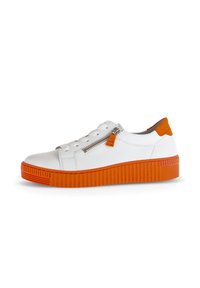 White sneaker with orange rubber sole. Features a textured, ridged design and a zip closure on the side. Smooth upper material.