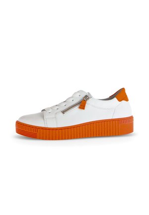 White sneaker with orange rubber sole. Features a textured, ridged design and a zip closure on the side. Smooth upper material.