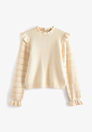 Jersey beige de punto con puños fruncidos, cuello con volantes y mangas abullonadas con un patrón calado.