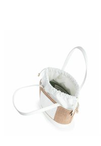 Bolsa de cordón con una parte superior de lona blanca y un fondo de tejido beige. Presenta una sola correa blanca y una textura suave y lisa.