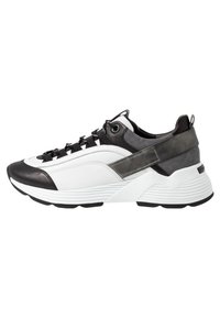 Sneaker bianca e nera con un mix di materiali lisci e testurizzati, caratterizzata da una suola spessa, un design con lacci e un accento audace nel pannello laterale.