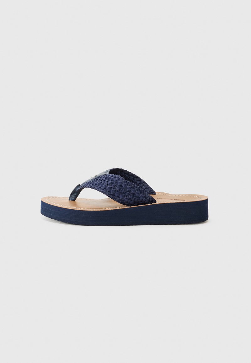 Navy blue flip-flop sandal with woven fabric straps and a cork-like sole. Features a textured strap and a slightly raised, dark base.