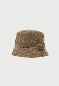 Brown bucket hat featuring a geometric pattern, soft textured fabric, wide brim, and a small logo tag on the side.