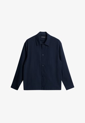 Chemise à manches longues bleu marine en tissu texturé avec col étalé, boutons à l'avant et ourlet droit.