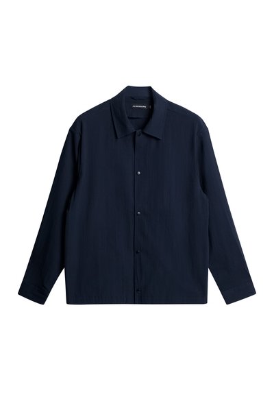 Marineblauwe langwerpige blouse gemaakt van gestructureerde stof met een gespreide kraag, knopen aan de voorkant en een rechte zoom.
