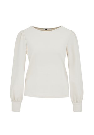 Blusa crema a maniche lunghe con texture, spalle imbottite e polsini aderenti, scollo rotondo, progettata per donne.