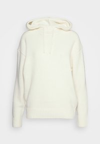 Biały, przesadnie duży hoodie wykonany z miękkiego dzianiny, z kieszenią kangurzą, sznurkami oraz ściągaczami przy mankietach i dolnym brzegu.