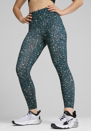 Højtragtede leggings i teal med leopardmønster. Lavet af strækbart materiale, med elastisk talje og tætsiddende design.