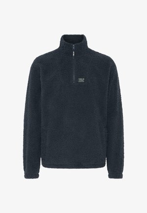 Donkerblauwe fleece pullover met een kwart-rits kraag, gestructureerde oppervlakte en een klein logo op de borst. Ontworpen voor warmte en comfort.